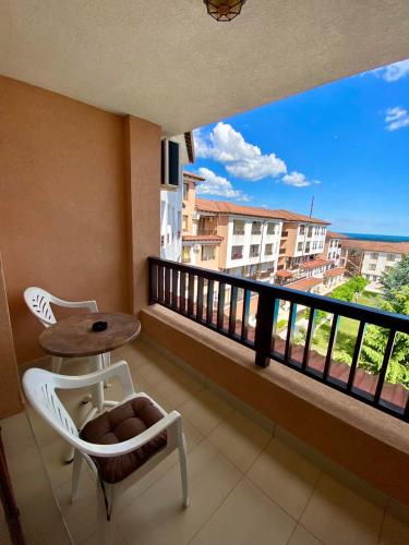 a balcony with a table and chairs and a table at Apartment C51 in Rogachevo