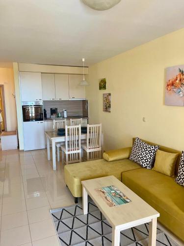 a living room and kitchen with a couch and a table at Apartment C51 in Rogachevo