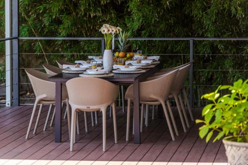 a dining table and chairs on a deck at Villa Hortensia-With Private Pool and Beaches Front in Mlini
