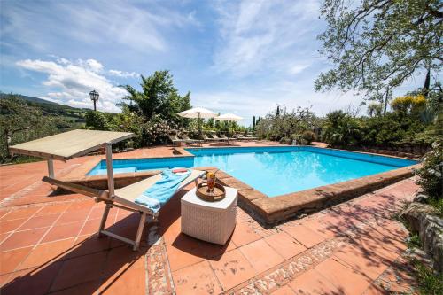 a swimming pool with a table and a chair next to it at Locanda dell'Angelo in Palazzo