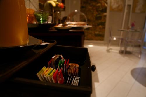 a black box filled withcolored toothbrushes in a kitchen at Art Boutique Hotel Acchiappasogni in Barga