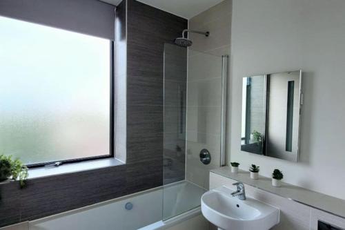 a bathroom with a sink and a glass shower at City view luxury by BSE Homes in Chelmsford