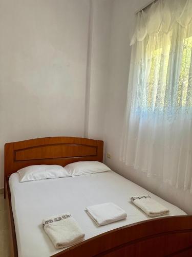 a bedroom with a bed with two towels on it at Albert Guest House in Borsh