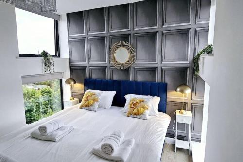 a bedroom with a white bed with two stuffed animals on it at City view luxury by BSE Homes in Chelmsford