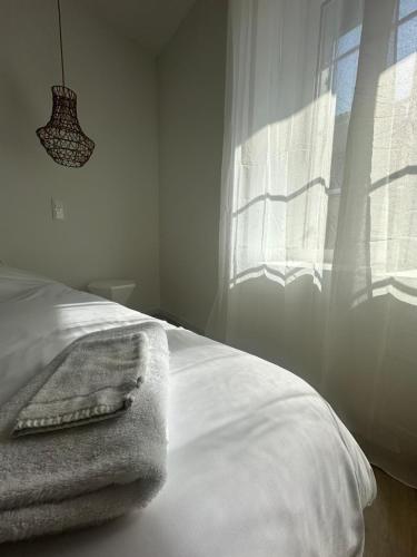 a bedroom with a bed with a towel on it at Appart-Hôtel Résidence de Garonne in Tonneins