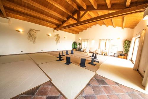a large room with a ceiling with wooden beams at Locanda dell'Angelo in Palazzo