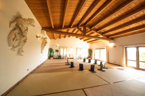 a large room with wooden ceilings and sculptures on the walls at Locanda dell'Angelo in Palazzo