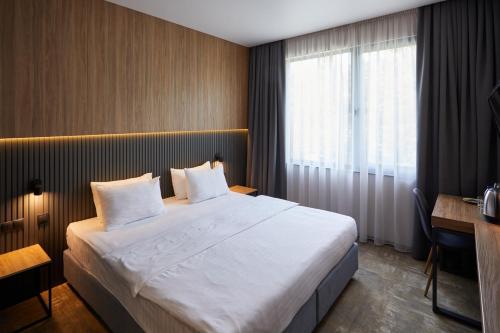 Una cama o camas en una habitación de Hotel Fregat
