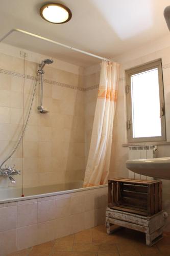a bathroom with a tub and a sink at Casa Morena in Spoleto