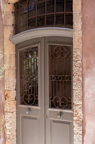 a door with a iron gate on a building at Qualia Slowlife Suites in Chania Town