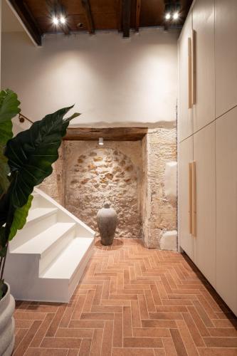 a bathroom with a stone wall and a white sink at Qualia Slowlife Suites in Chania Town