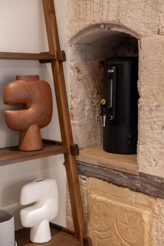 a shelf in a bathroom with a toilet and a mug at Qualia Slowlife Suites in Chania Town