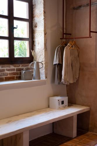 a kitchen with a bench with a microwave on it at Qualia Slowlife Suites in Chania Town