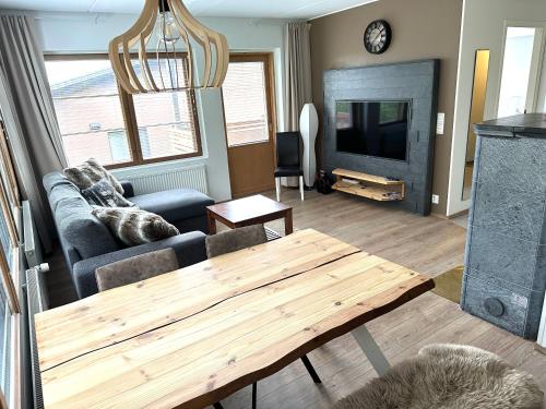 a living room with a couch and a wooden table at Ruka Center Chalet 3B1 in Ruka
