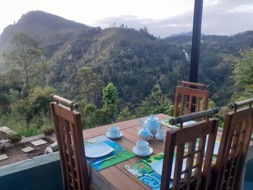 a wooden table with a view of a mountain at Ella floating view in Ella