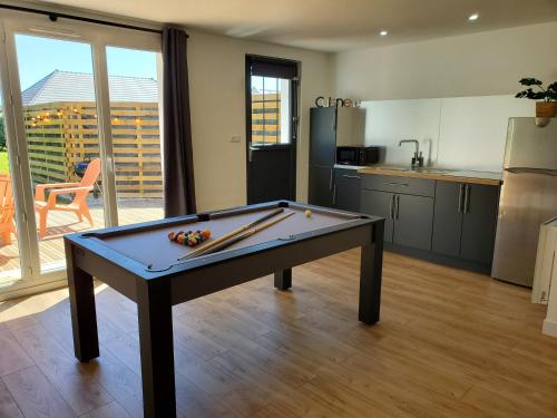 a ping pong table in the middle of a kitchen at Gite des Plantis in Senneville-sur-Fécamp
