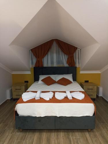 a bedroom with a large bed with towels on it at Villa Vineyard in Fethiye