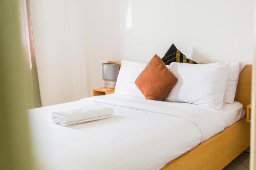 a white bed with white sheets and pillows at Accra Luxury Apartments at Clifton Place in East Legon