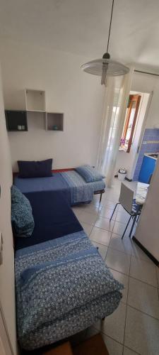 a bedroom with two beds and a living room at Mar Do Sol in Agnone