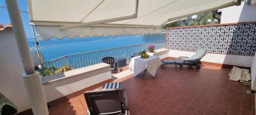 a balcony with chairs and a table and water at Mar Do Sol in Agnone