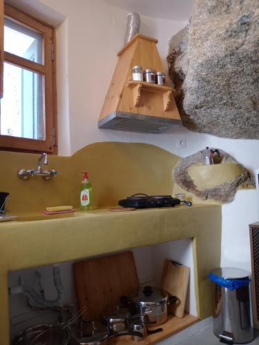 a kitchen with a sink and a stove top oven at ZACHAROULA ROOMS 2 in Manganítis
