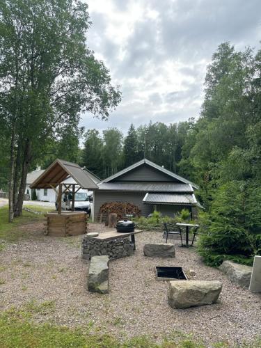 a backyard with a fire pit and a building at Green Forest Oasis & Sea in Strömstad