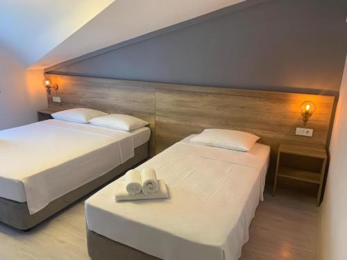 a bedroom with two beds and a table with towels at Rinascente in Edirne