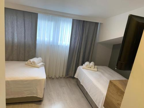 two beds in a hotel room with towels on them at Rinascente in Edirne