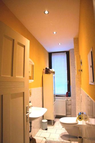 a bathroom with a sink and a toilet and a window at Forest Charm and Gems in Idar-Oberstein