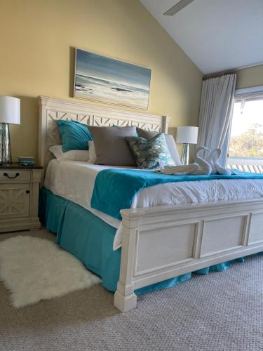 a bedroom with a large bed with blue and white at The Brighton on the Marsh in Riverview