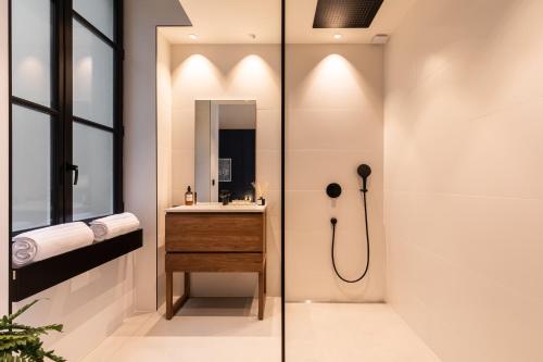 a bathroom with a shower and a sink at MOHOM - Bellecordière in Lyon
