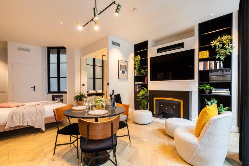 a living room with a table and a fireplace at MOHOM - Bellecordière in Lyon