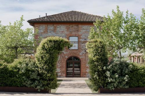 a brick house with an archway in front of it at Agriturismo Mascudiera in Fiorenzuola dʼArda