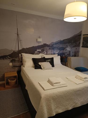 a bedroom with a large bed with towels on it at Old port in Baška Voda
