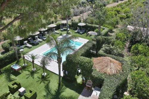 an overhead view of a resort with a pool and chairs and trees at Le Zagare in Lascari