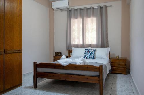 a bedroom with a bed with towels on it at Villa Kali-mera in Sykia Chalkidikis
