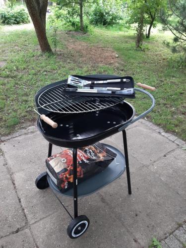a grill with two hot dogs on top of it at Noclegi w Dolinie Drwęcy in Kurzętnik