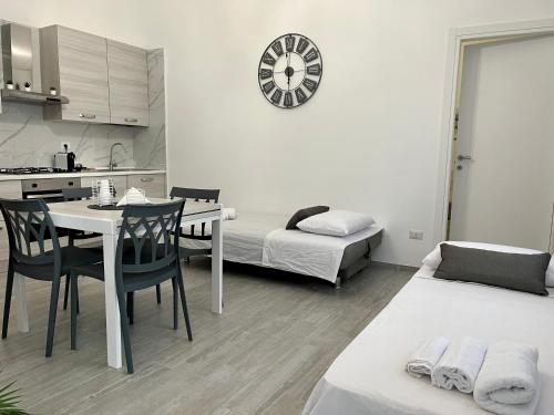 a kitchen and living room with a table and chairs at Room 28 in Conversano