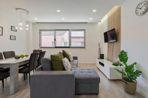 a living room with a couch and a table at Guest house in Barreiro