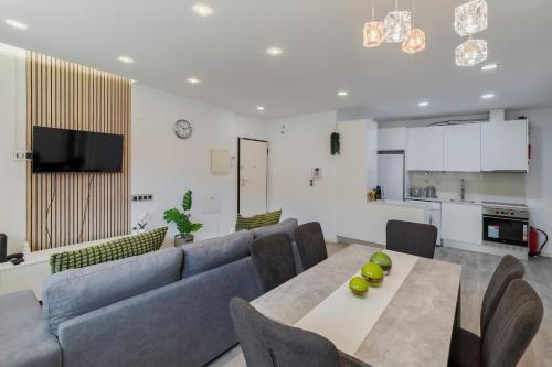 a living room with a couch and a table at Guest house in Barreiro