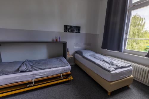 Katil atau katil-katil dalam bilik di Motel Home Wittenau