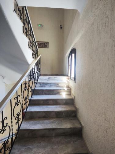 a staircase in a building with a stair railing at HOTEL IREON beach in Samos