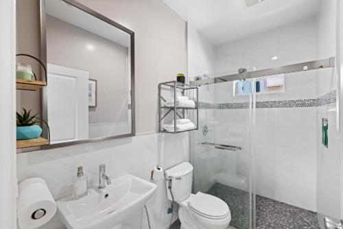 a bathroom with a toilet and a sink and a shower at Stylist Home In Convenient Location! in Temple City