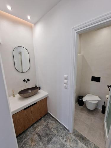 a bathroom with a sink and a toilet at Smaro Studios in Firostefani