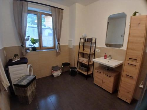 a bathroom with a sink and a mirror at Appartements Kumming - Urlaub inklusive Nationalparkcard in Rauris