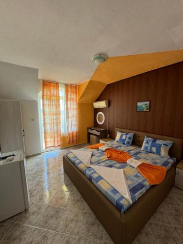 a bedroom with a large bed in a room at Hotel Laguna - Guest House in Primorsko