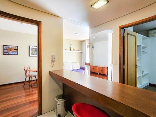 a home office with a desk and a red chair at Saint Moritz 204 a 2 quadras da Rua Coberta in Gramado