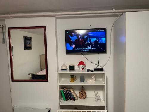 a living room with a television on a wall at İstanbul apartment 1 in Belgrade