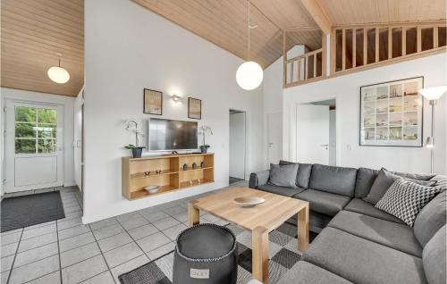 a living room with a couch and a table at 3 Bedroom Stunning Home In Nørre Nebel in Nørre Nebel