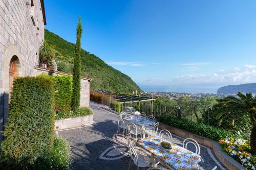 a group of tables and chairs on the side of a building at Holidays Homes The dream in Sant'Agnello